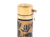 a small vase with a gold lid on a white background