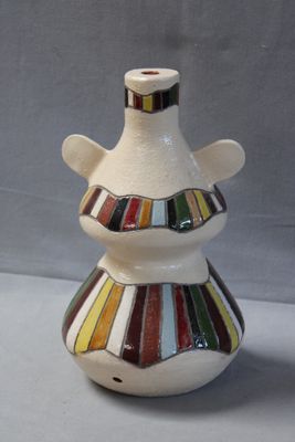 a white vase with a multicolored design on it