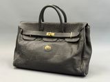 a black leather handbag with gold hardware on the handle