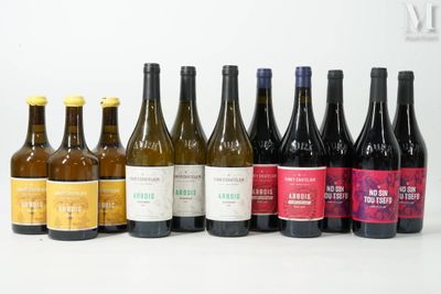 several bottles of wine are lined up on a white surface