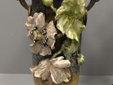 two vases with flowers on them on a table