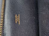 a close up of a black leather purse with gold zippers