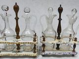 four glass decanters and a wooden stand on the table