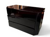 a black dresser with a mirror on top of it
