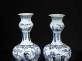 pair of blue and white vases on a black background