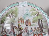 a plate with a picture of a group of people on it