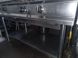 a large stainless steel stove with three burners on it