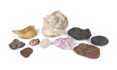rocks and stones are arranged on a white surface