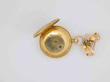 an image of a gold pocket watch with a bee on it