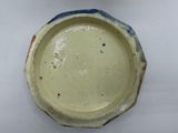 a close up of a bowl on a white surface