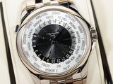 a silver watch with a black face on display