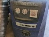 an image of a vacuum cleaner sitting on the floor next to a pile of junk