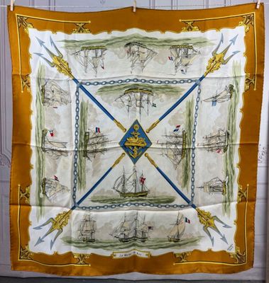 a yellow and white scarf with a picture of a sailboat on it