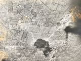 an aerial view of a city with a lot of smoke coming out of it