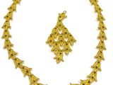 a gold necklace and earring set with green stones