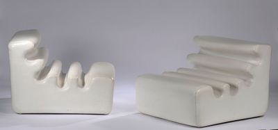 a white chair and a chair that are sitting next to each other
