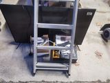 a metal ladder that has a bunch of items on top of it