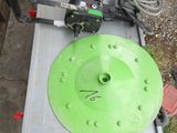 a table with a green disc on it in the yard