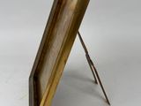 an antique brass easel with a wooden frame and a metal stand
