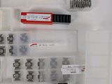 many different types of screws and nuts in this case