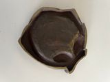 a small brown bowl on a white table