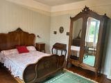 a bedroom with a bed, dresser, mirror, and rug