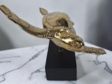 brass statue of a bird on a marble base