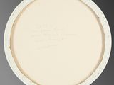 an oval white plate with writing on the rim of it