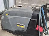 a black and gray machine that is sitting on the ground