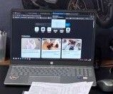 a laptop computer sitting on a desk next to a mouse and keyboard