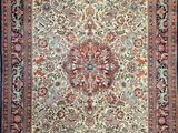 an antique persian rug with a floral design on a blue background