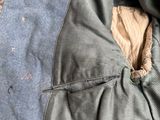 a blue jacket with a hole in the middle of it
