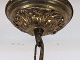 a close up of a light fixture with a chain hanging from the ceiling