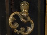 a close up of a door handle on a black cabinet