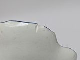 a small white bowl with a blue stripe on it