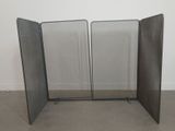 a three panel screen in the middle of a room