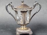 un trophée ancien en métal plaqué argent, muni d'un couvercle en verre et d'un socle en métal