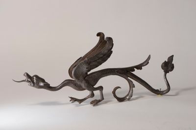 an image of a metal sculpture of a bird with wings