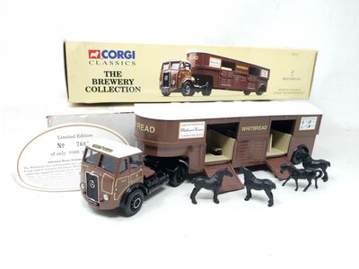 a toy truck with horses and a horse trailer in it
