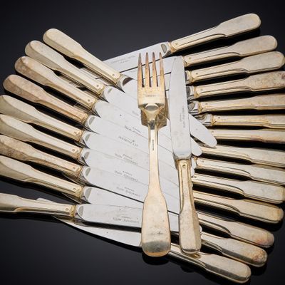 a lot of forks and knives that are on the table