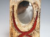 a small square shaped object with a red cross on it