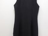 the back of a black dress hanging on a hanger