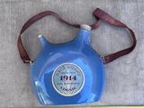 une cruche bleue munie d'une sangle marron et d'un mètre ruban