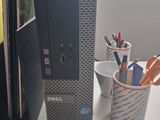 a desktop computer sitting on a desk next to a cup of pens and pencils