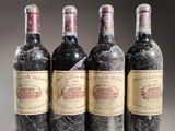 four bottles of wine are lined up in a row