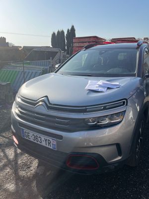 the citrole is parked on the side of the road in front of a fence