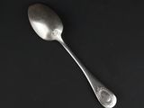 a spoon that is sitting on a black surface