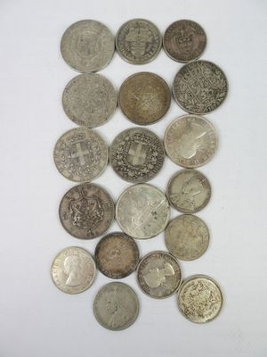 several different types of coins are arranged on a white surface