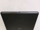 the back of a black laptop computer sitting on top of a white table