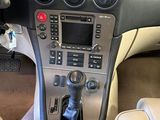 a dashboard of a car with a steering wheel and a control panel